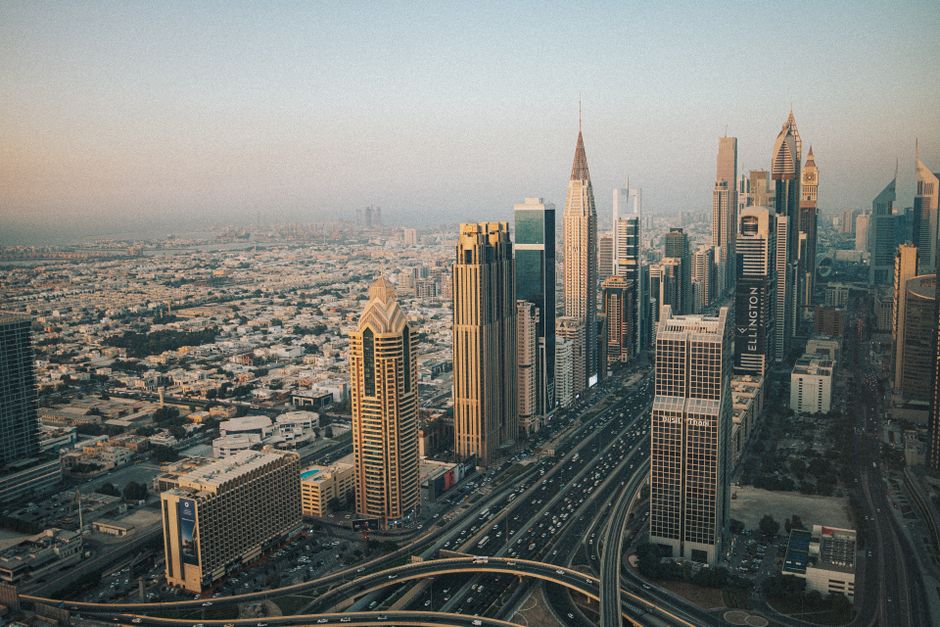 services-01 Stunning aerial shot of Dubai's modern skyline with iconic skyscrapers at dusk.